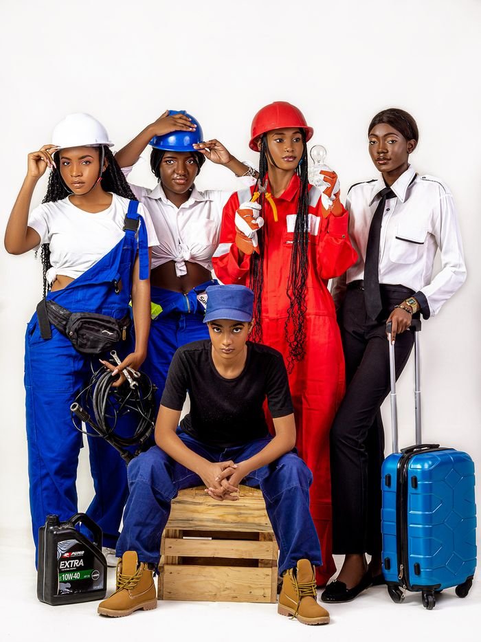 Group of African women showcasing various professions in colorful uniforms on a white backdrop.